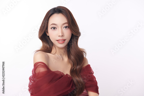 A beautiful young Asian woman with clean, fresh skin against a white background. Skincare, facial treatment, cosmetology, beauty, and spa. An elegant portrait of an Asian woman.