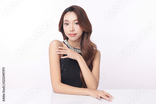 A beautiful young Asian woman with clean, fresh skin against a white background. Skincare, facial treatment, cosmetology, beauty, and spa. An elegant portrait of an Asian woman.