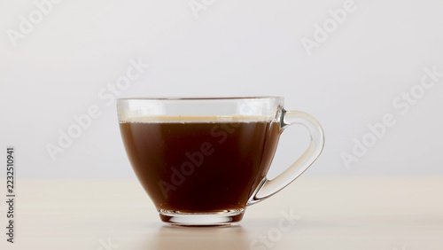 Fotografie Clear Glass Cup Filled with Fresh Black Coffee on Table