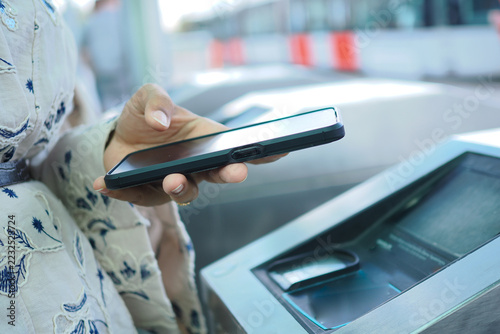 Obraz na plátně a person using a smartphone for a contactless NFC scan at a public transport tur