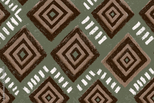 Geometric textile pattern with brown diamond shapes, sage green background, and distressed white accents creates rustic tribal surface design