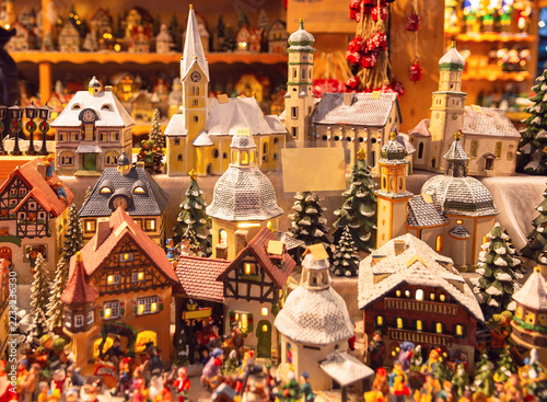 Miniature Christmas village with illuminated houses, snowy rooftops and festive decorations at Salzburg Christmas market.