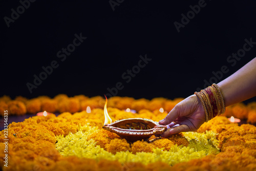 Clay diya lamps lit during diwali celebration, Diwali, or Deepavali, is India's biggest and most important holiday.