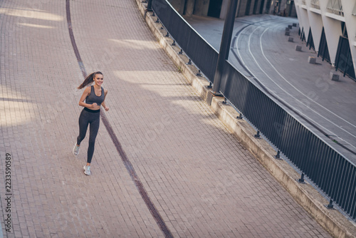Top above high photo of motivated positive sportive lady run hobby want reach win finish line outside gym