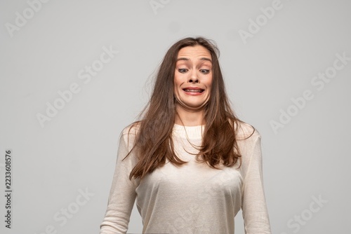 Fotografie Woman making disgusted face, cringing from unpleasant odor or taste, feeling gro