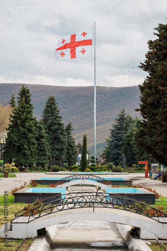 Obraz na plátně Stalin Park with fountain channel, fir trees and a Georgian flag in Gori, Georgi