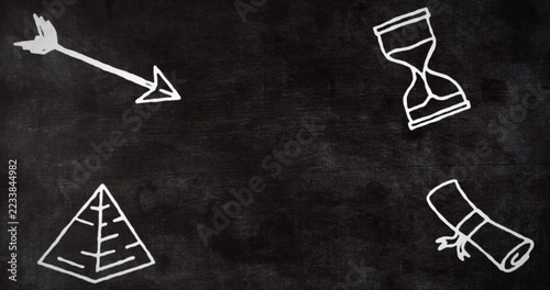 Displaying dark chalkboard in classroom, showing chalk arrow, pyramid, hourglass and scroll