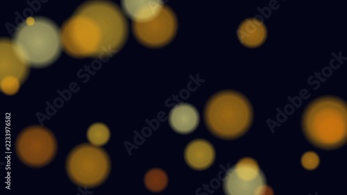 Golden bokeh light particles float gently across a dark night background creating an elegant festive abstract visual effect with glowing soft blurred circles for holiday celebration backdrops