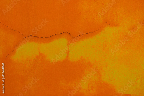 Obraz na plátně An orange-painted concrete or plastered wall surface featuring visible hairline to moderate cracks and dampness or discoloration patterns