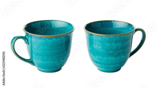 Fotografie Two matching turquoise ceramic mugs with reactive glaze and brown rim detail