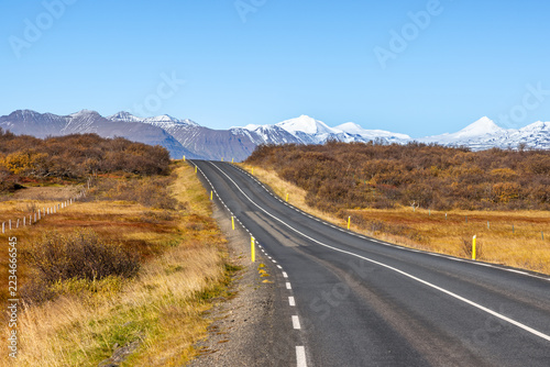 Snow covered mountain view in the Borgarbyggd region of western Iceland, as seen from the Route One ring road near Fiflholt. Autumn colours and main road.