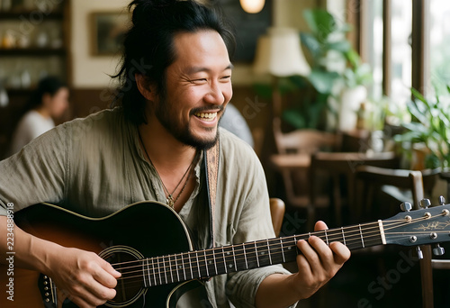 Creative hobby and leisure, happy man playing acoustic guitar in a cozy cafe, musician enjoying music practice and artistic lifestyle in coffee shop