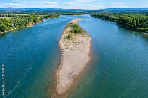 Aerial view of a river sandbar dividing the water into two channels.