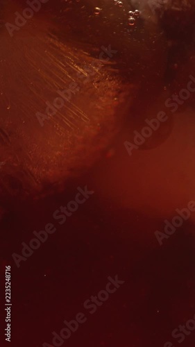 The preparation process for a refreshing summer cocktail. A shot of espresso is poured into a glass containing mineral water, ice, and other ingredients. A coffee-based drink.