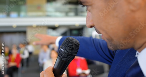 Obraz na plátně Close-up of a Caucasian male speaker speaking and pointing someone in the busine
