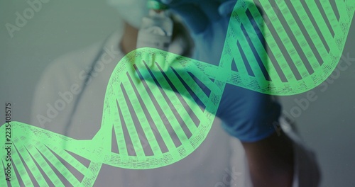 Green DNA helix graphic covering blurred masked worker in white coat handling lab item, copy space