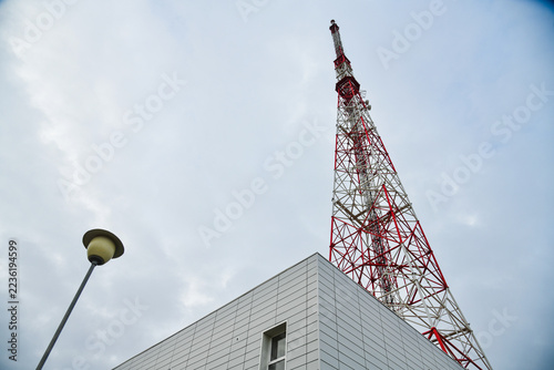 Telecommunications tower, a masthead television antenna against a cloudy sky.