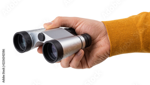 Obraz na plátně Hand holding modern compact silver binoculars with black rubber eye cups