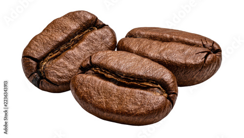 Obraz na plátně Three roasted dark brown coffee beans with textured surfaces