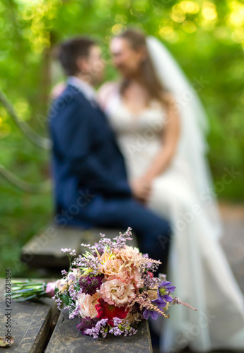 Wedding Couple with Bridal Bouquet in Nature