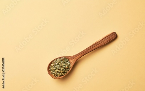 Delicate Minimalist Flat Lay of Linden Herb on Wooden Spoon against Soft Yellow Background
