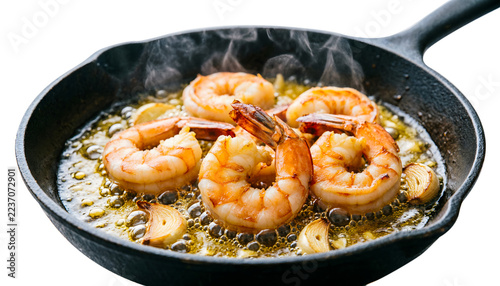 Eye-level shot of sizzling butterflied garlic prawns in a hot pan, pink flesh curling, garlic oil bubbling intensely, on a white background.