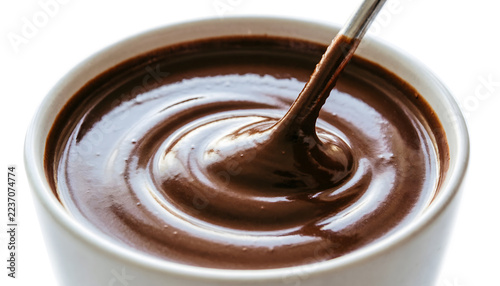 Close-up top-down of rich hot chocolate being stirred, glossy swirling surface, velvety liquid texture, on a white background.