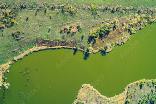 Abstract green river meander with vibrant landscape textures and bright natural contrast, drone shot