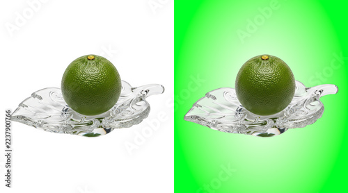 Fresh green lime fruit placed on a clear glass leaf shaped dish on white background